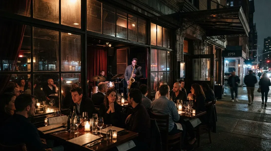 Smoke Jazz & Supper Club en Broadway de noche, mesas iluminadas con velas que brillan a través de la ventana con un saxofonista en el escenario